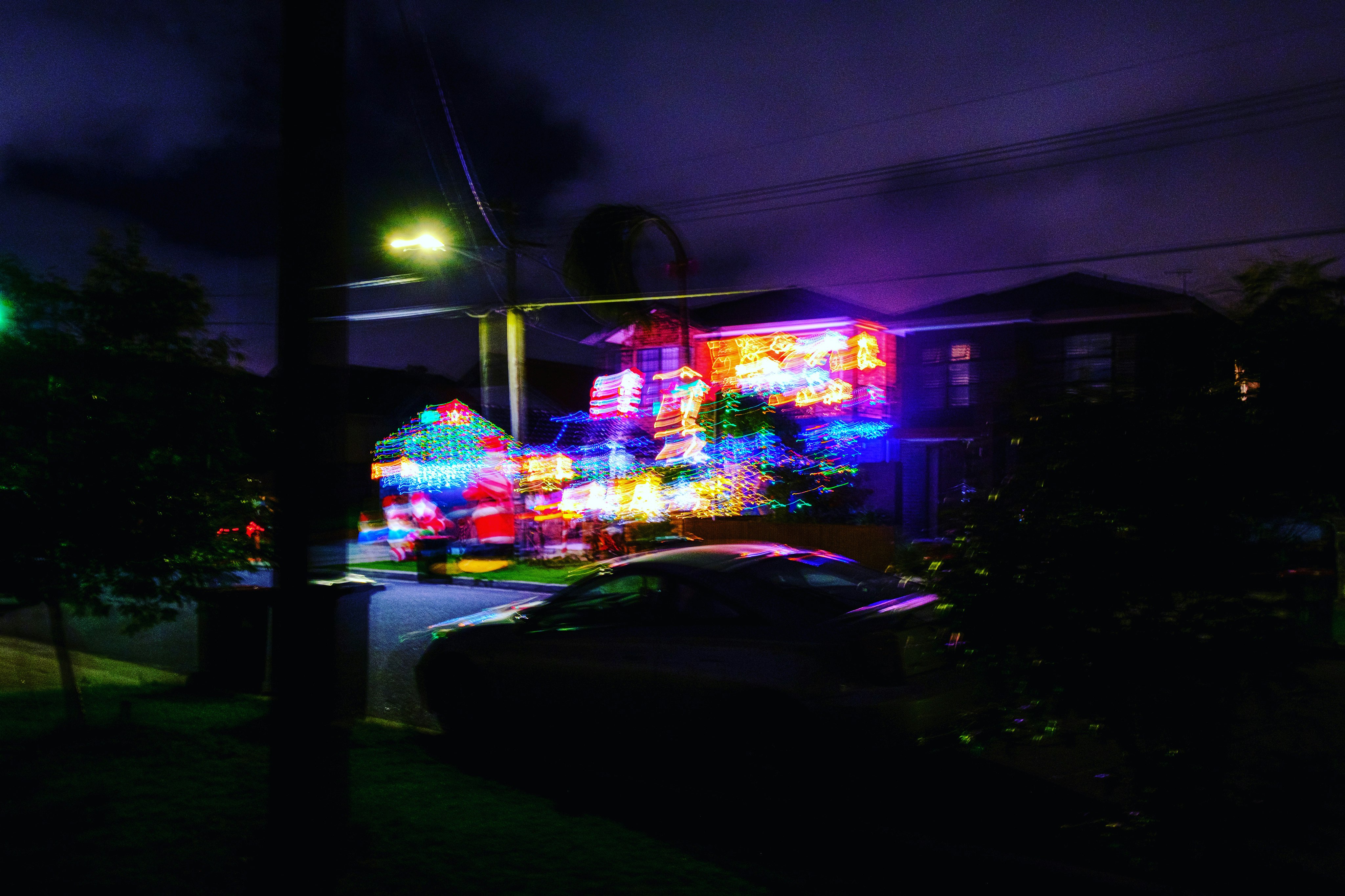 cars parked in front of store during night time